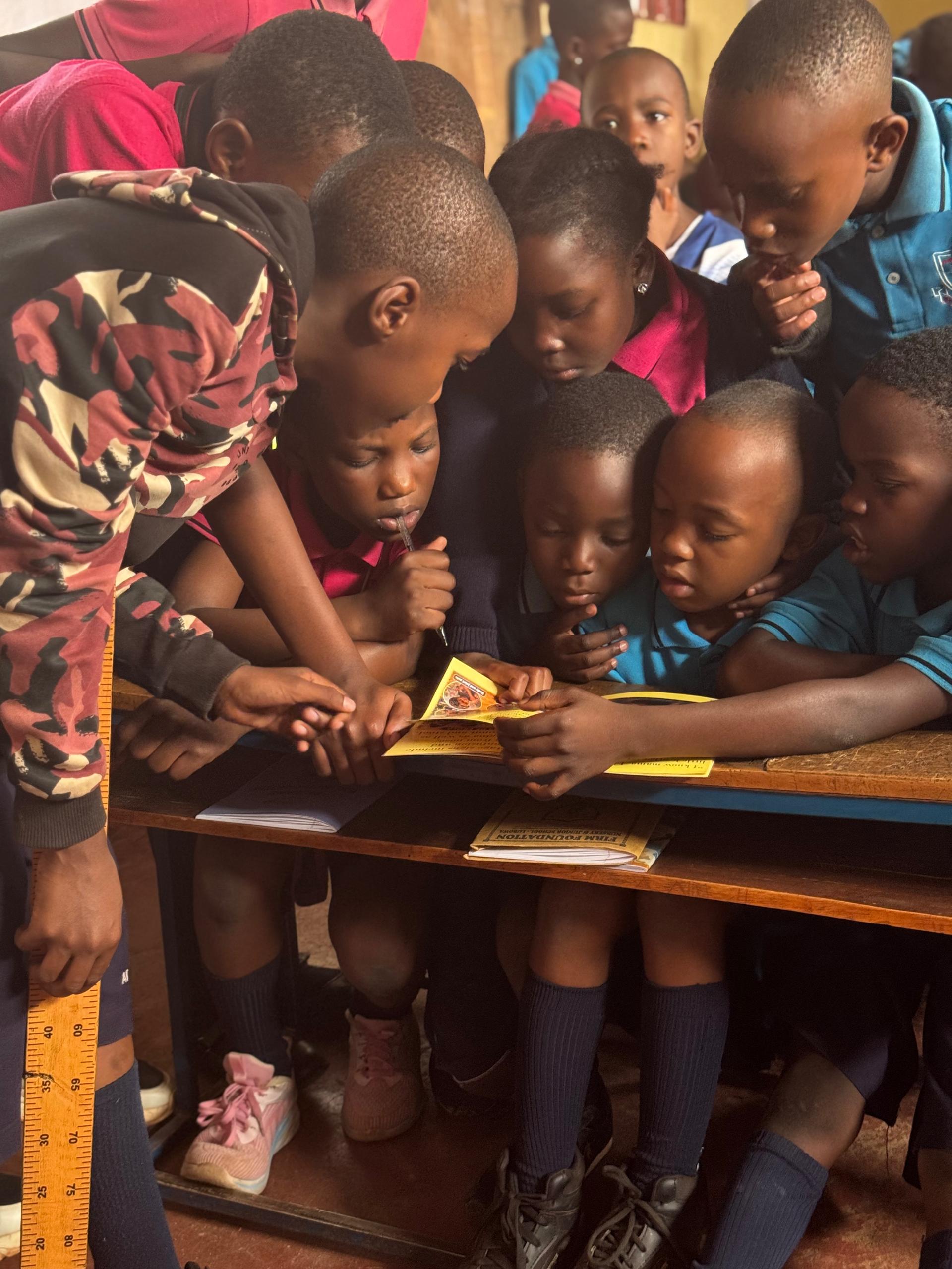 Children reading health education materials